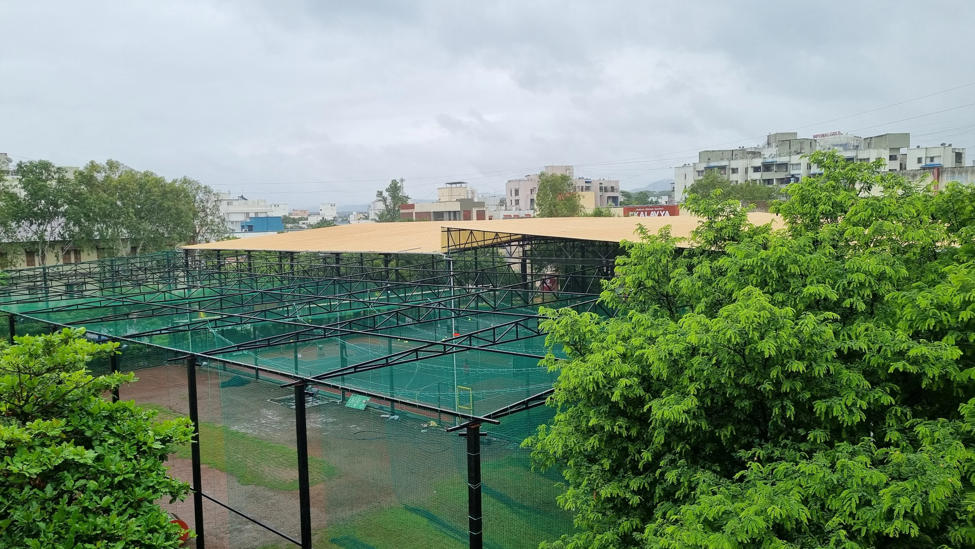 Outdoor sports courts surrounded by mature green trees