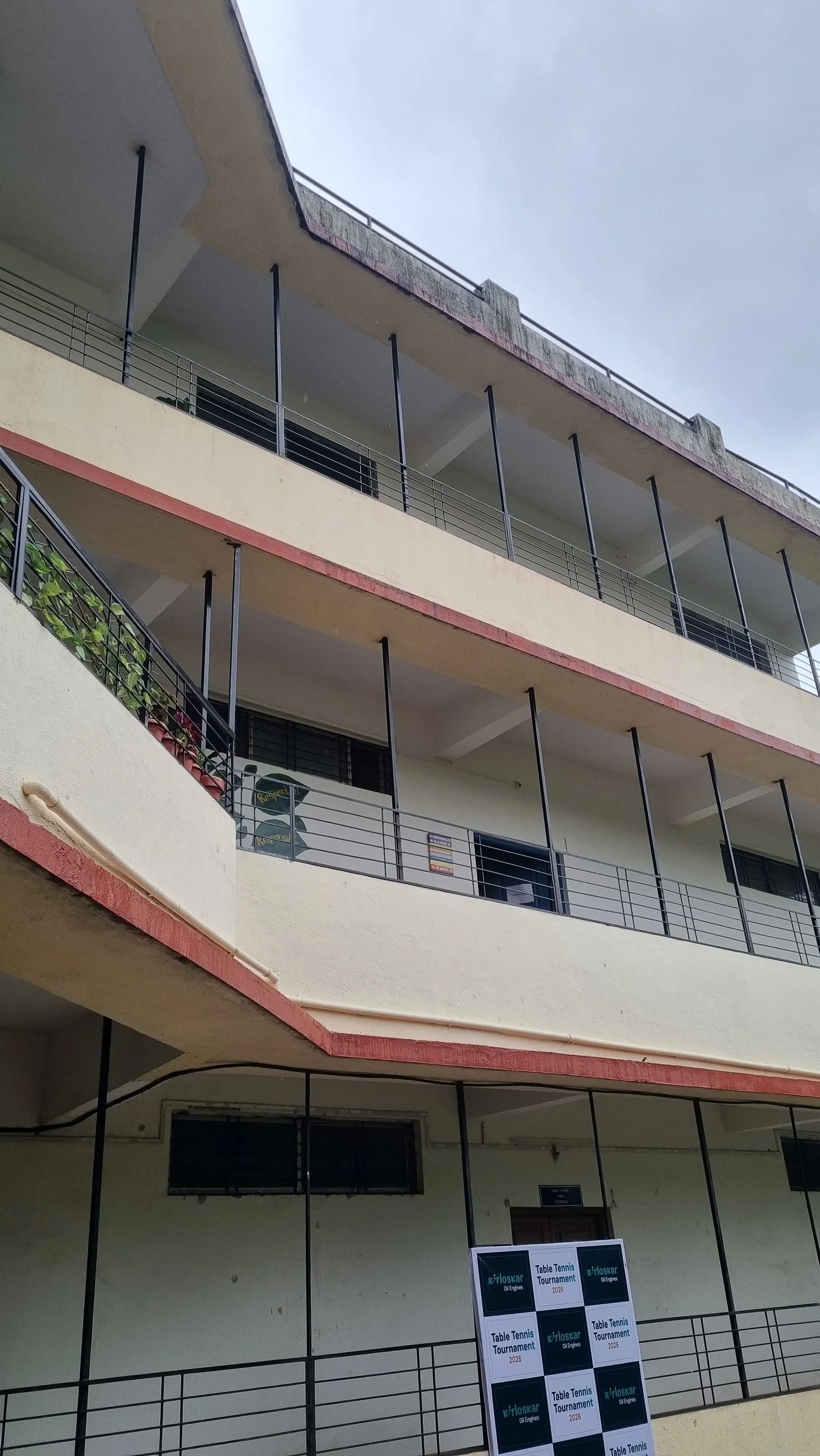 Multi-storey academic building with open corridors viewed from the courtyard